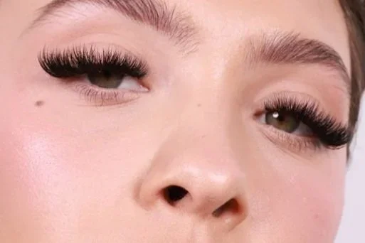 Close-up of a model with full, fluffy lash extensions